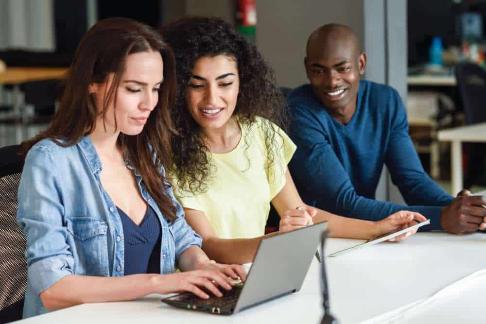 Colleagues reviewing information together on a laptop